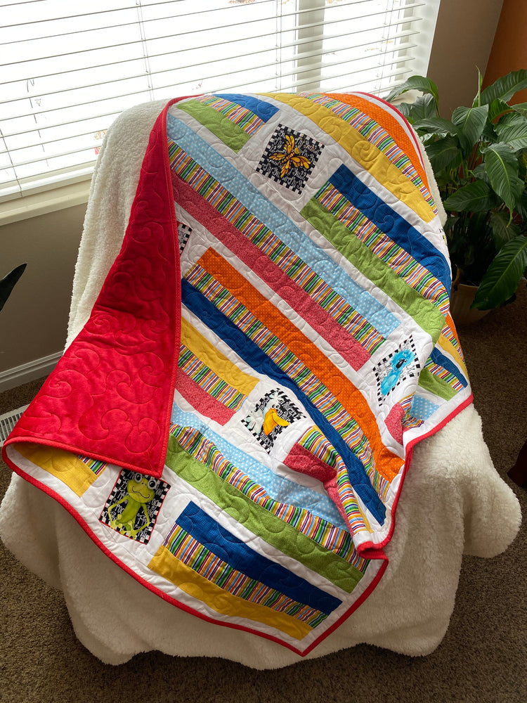 Wonky Strip Quilt for a boy or girl with a plush red minky back