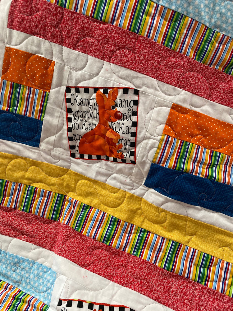 Wonky Strip Quilt for a boy or girl with a plush red minky back