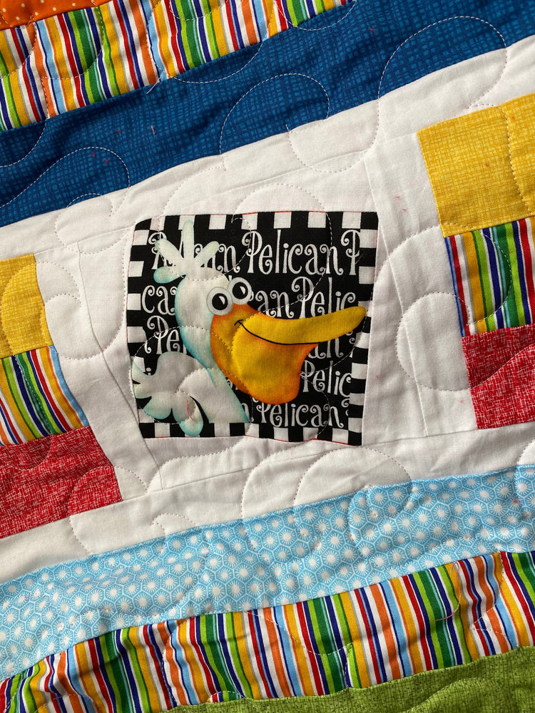 Wonky Strip Quilt for a boy or girl with a plush red minky back